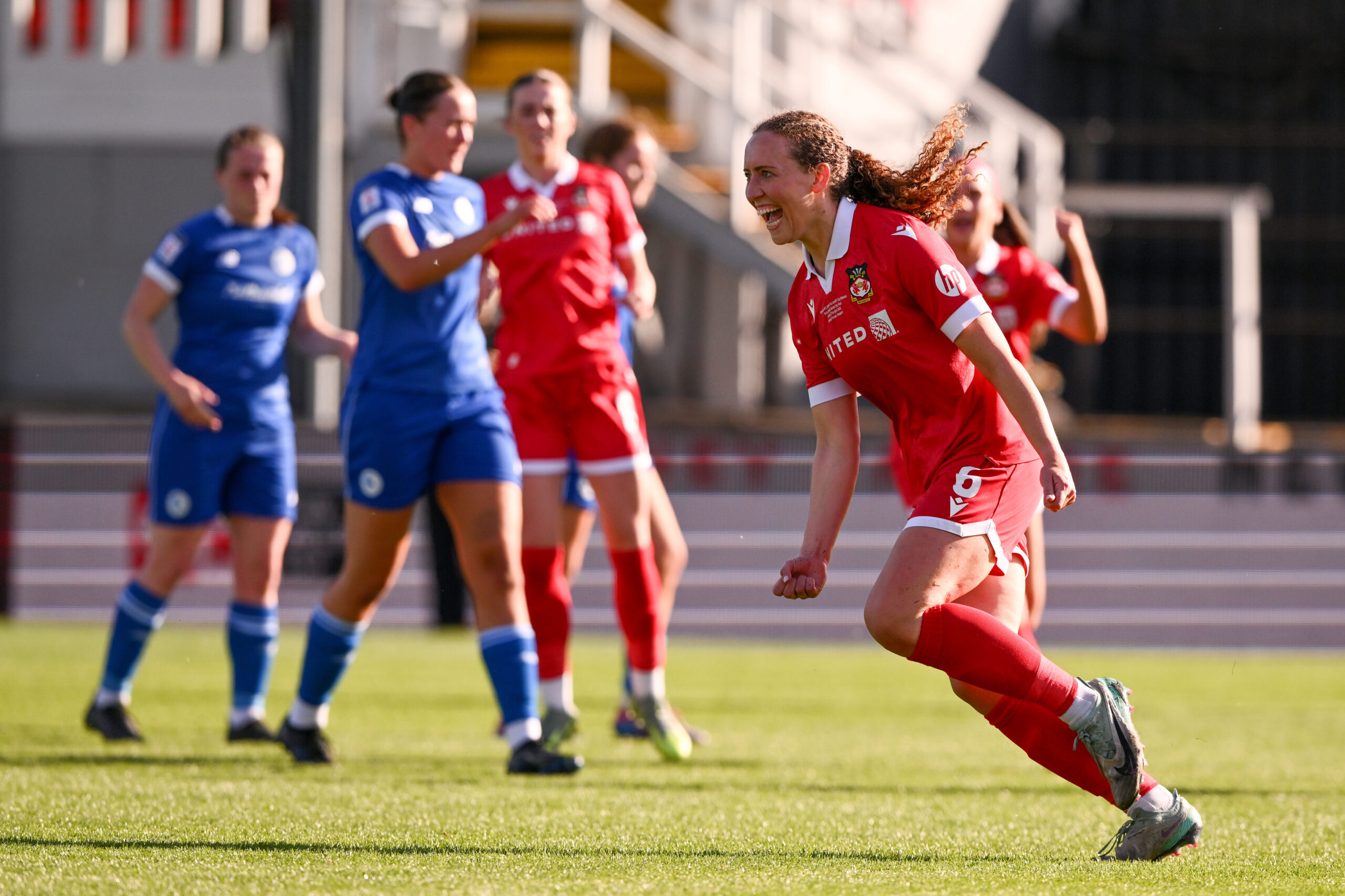 Wrexham AFC Women's Abbie Iddenden celebrates scoring her sides first goal during the 2024/25 Bute Energy Welsh Cup Final fixture between Wrexham AFC Women & Cardiff City Women FC at Rodney Parade, Newport, Wales